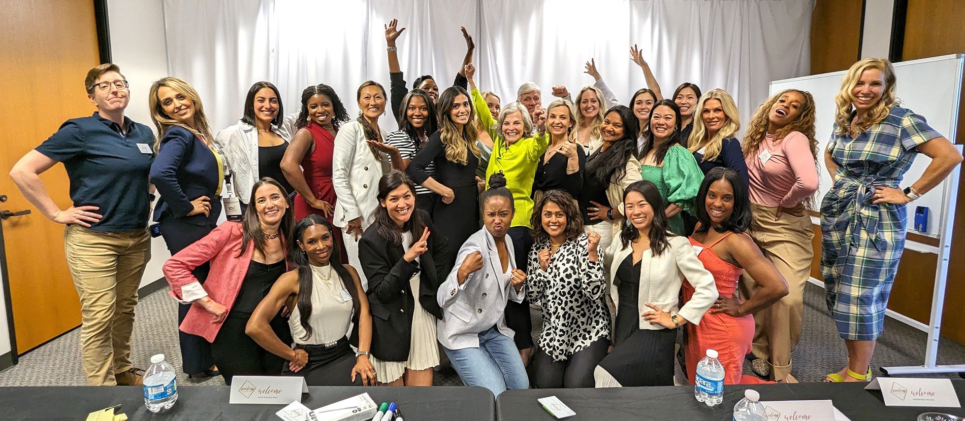 Glidewell female dentists striking power poses in a training room