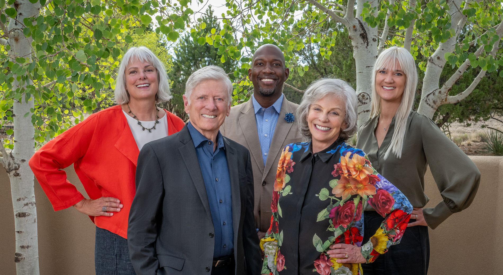 Deborah, David and the Eloqui team standing among aspen trees